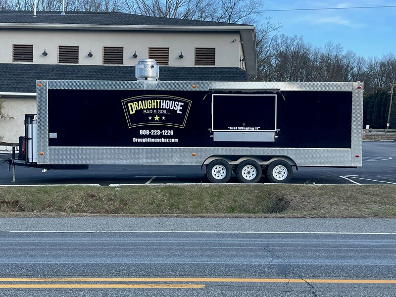 Black and chrome food truck that says Draught House Bar & Grill